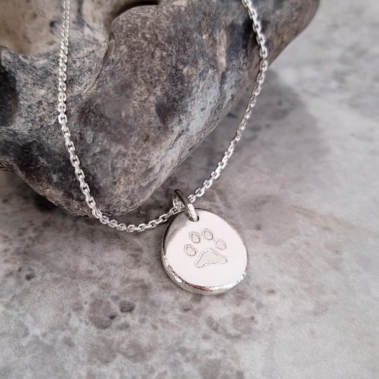 Silverhalsband med ett tassavtryck från hund